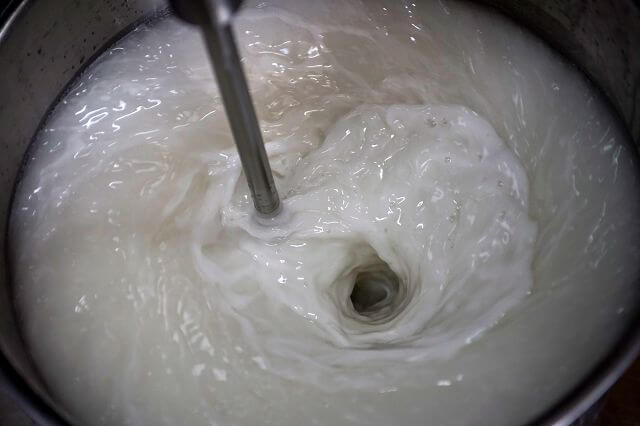 White liquid in industrial mixer