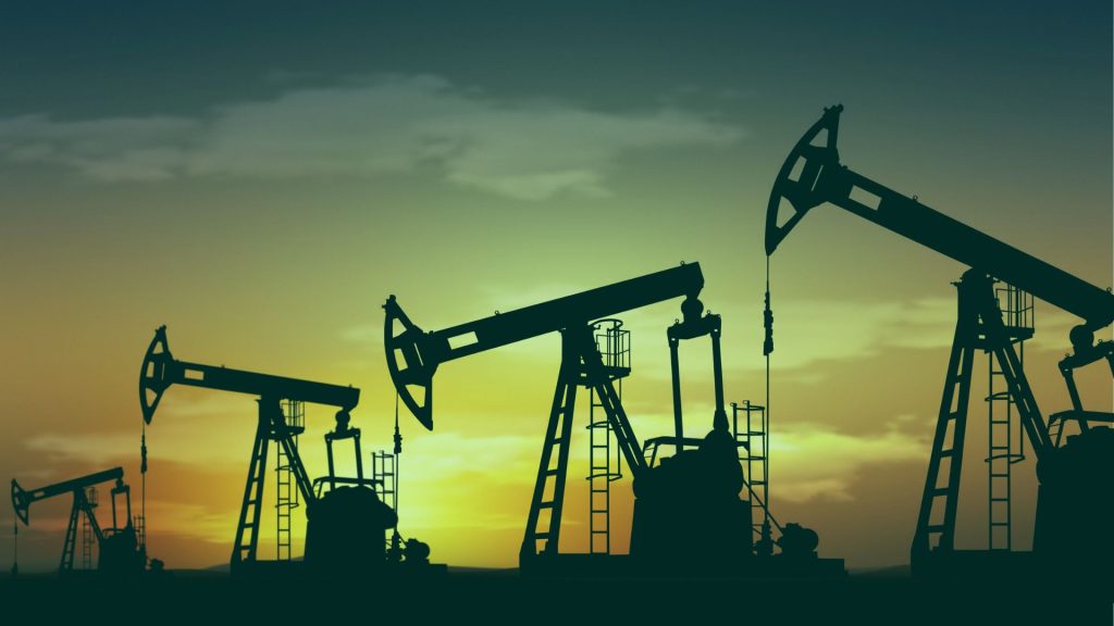 Oil drilling machines at sunset